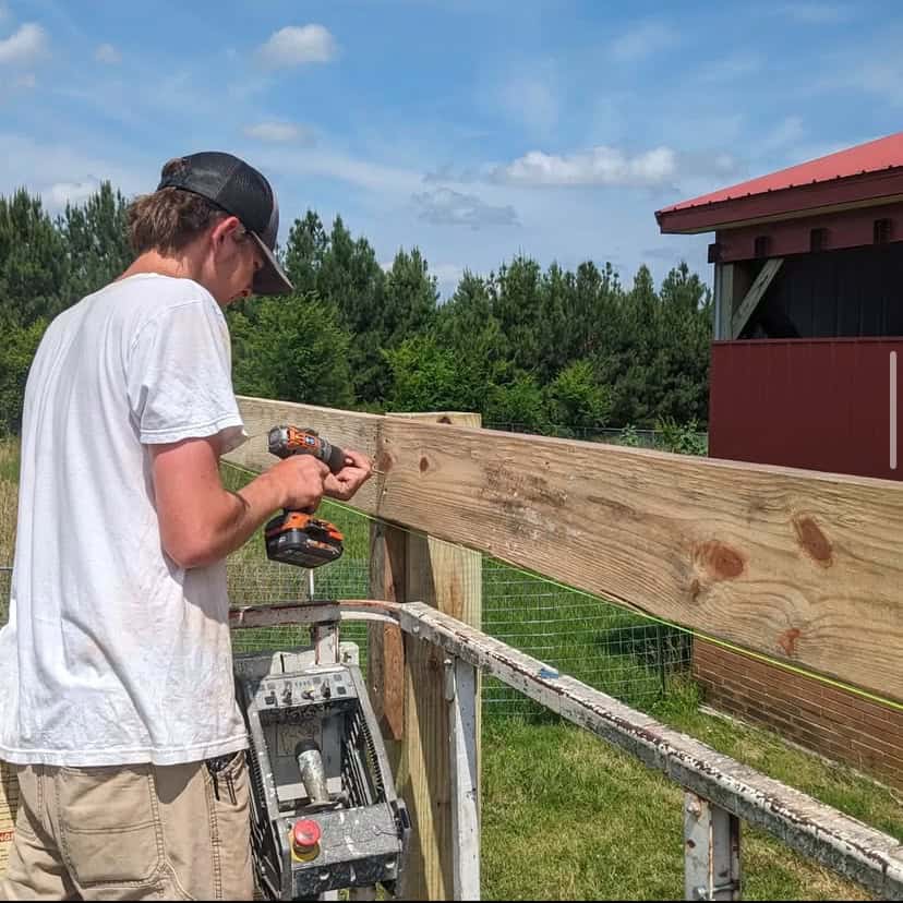 Davie County FFA member Nathan Harris works on the barn’s extension.