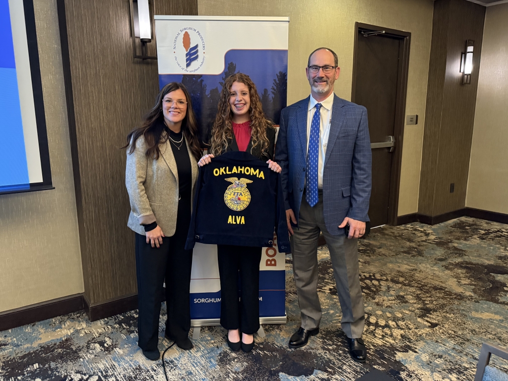 NSP Chairmen Amy France (left) and NSP CEO Tim Lust (right) take a photo with Alva FFA Chapter Reporter Katelee Martin (middle).