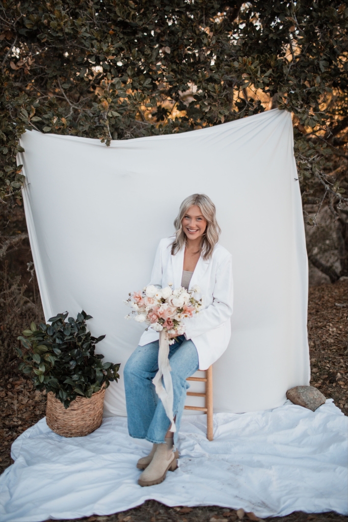 Liberty Ranch FFA Alum Lexi Lupton poses with a bouquet.