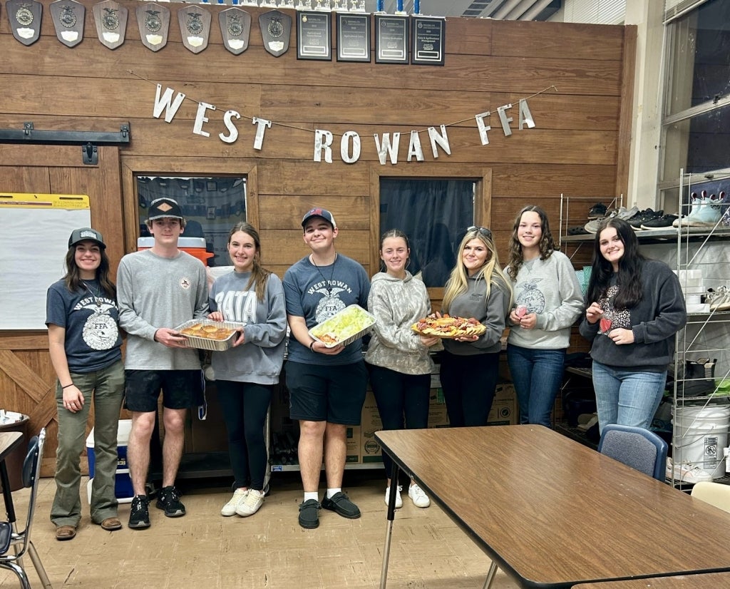 West Rowan FFA members Emry Starnes, Isaiah Leonard, Reagan Helmbold, Caleb Kimbrough, Savannah Meadows, Virginia Walser, Mollie Sullivan and Avery Jenkins prepare to serve at the alumni and supporters dinner.