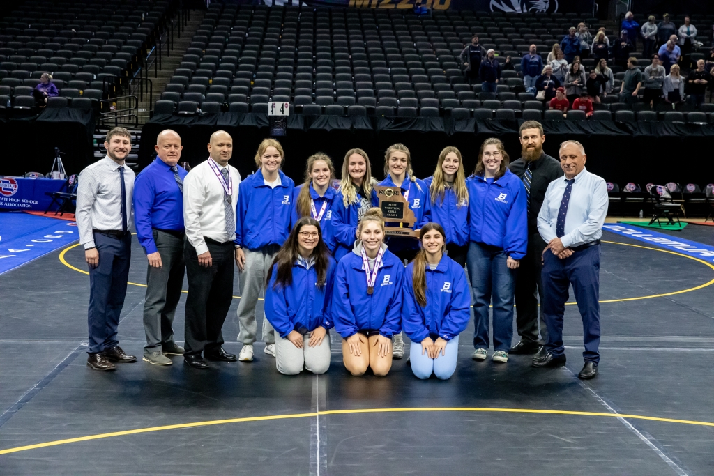 Six members of the Brookfield FFA Chapter, along with their teammates and coaches, gather with their second place trophy at the MSHSAA State Wrestling Championships.