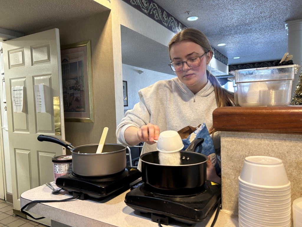 Addison Hand preparing the mix for no-bake cookies for the residents.