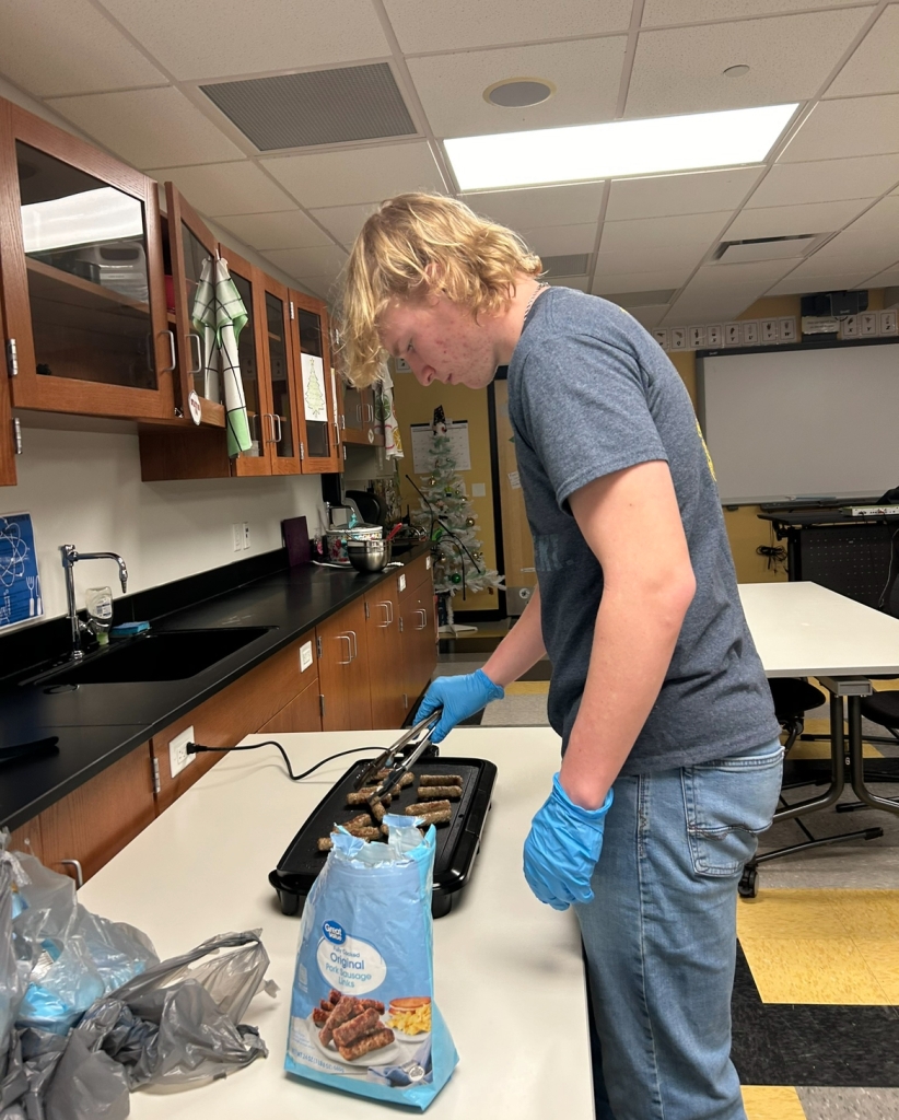 Chapter Sentinel. Owen Bigler, preparing food for the teacher breakfast.