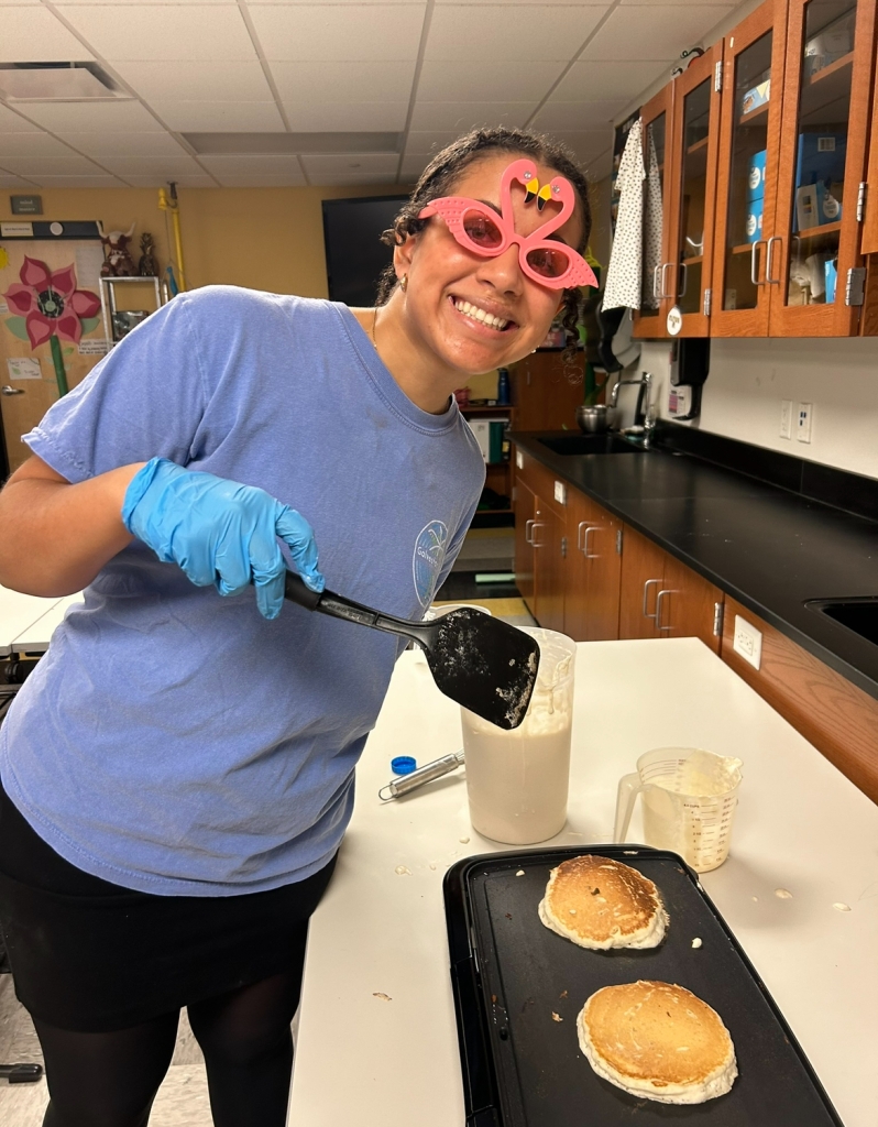 Chapter Vice President, Breanna Stratton, making pancakes for the faculty breakfast.