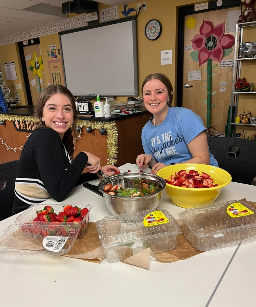 Shelby Dimiceli and Addison Hand preparing fruit for the Teacher Breakfast.