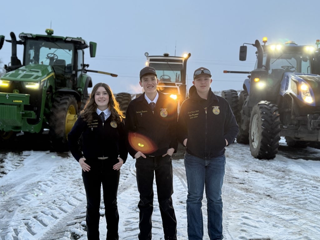 Sunnyside FFA members pose in front of their tractors during Drive Your Tractor to School Day.