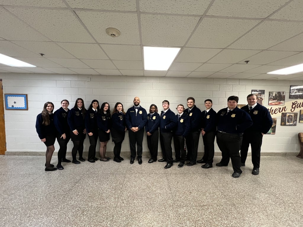 Southern Guilford FFA members gather with Principal Dr. Boone, an FFA Alumnus (center), after giving him his first FFA jacket.