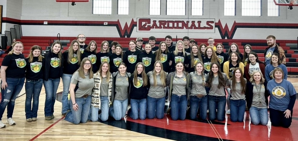 Van Dyke smiles for a picture with North Clay FFA members in their FFA apparel during the 2025 National FFA Week.