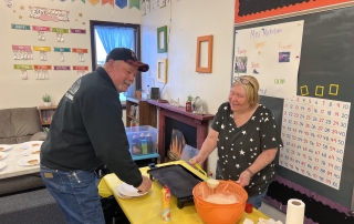 Alumni Members Kim and Donny Thompson making pancakes for the kids.