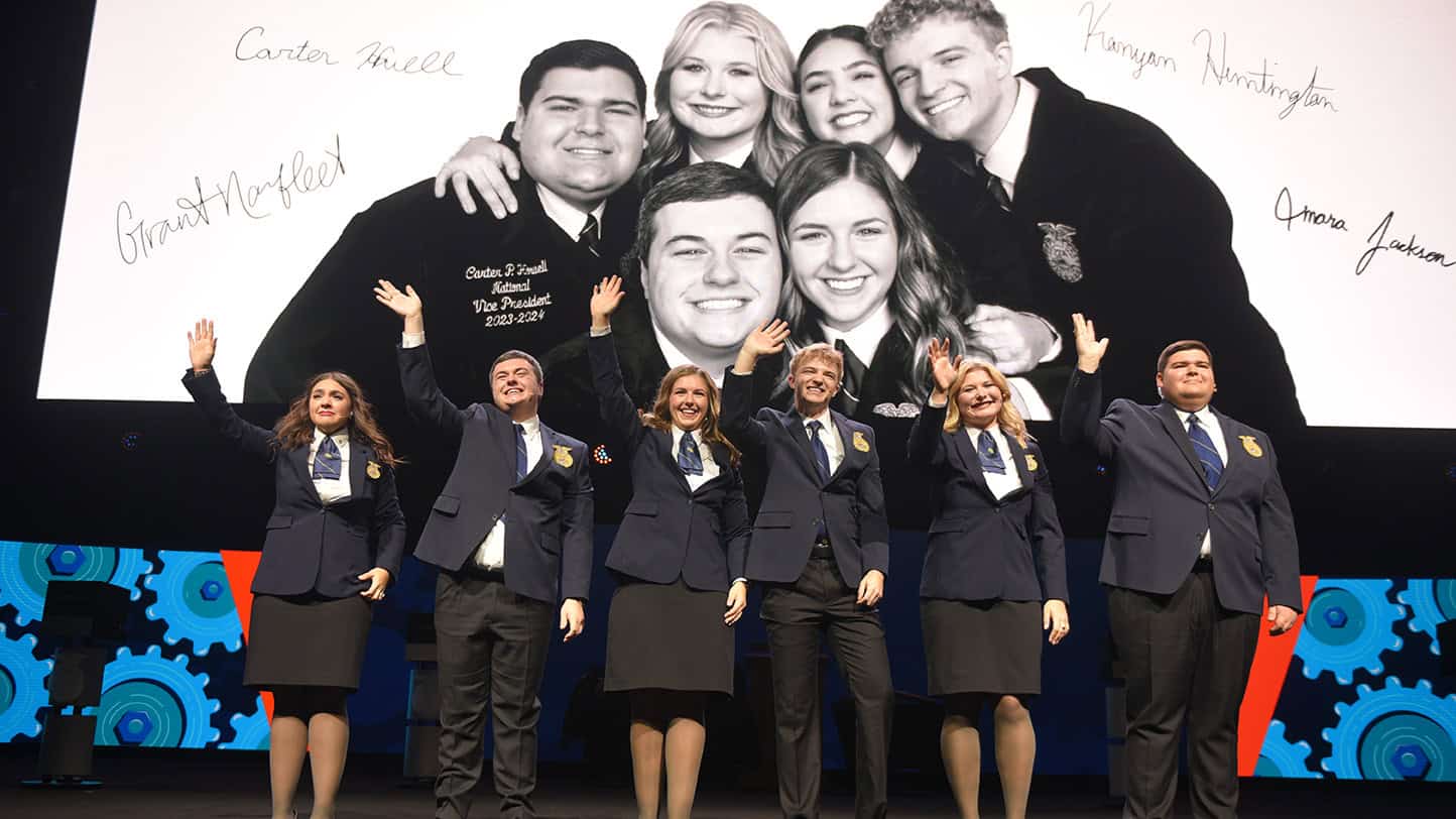 The 2-23-24 National FFA Officer Team waving goodbye from the convention stage.