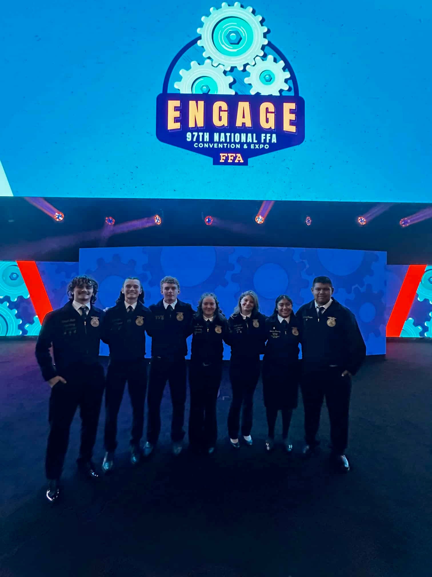 Maggie Alford (fifth from the left) and her new friends smile on stage at the 97th National FFA Convention & Expo.